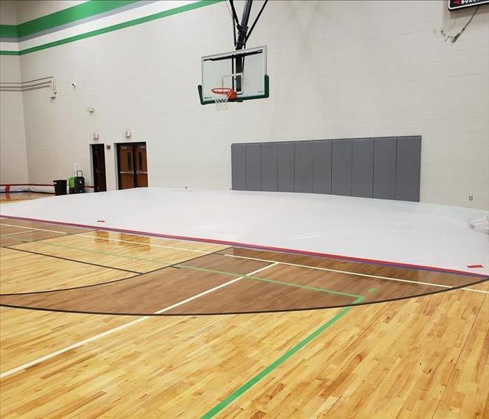 School gymnasium with an area covered with a deflated tarp.