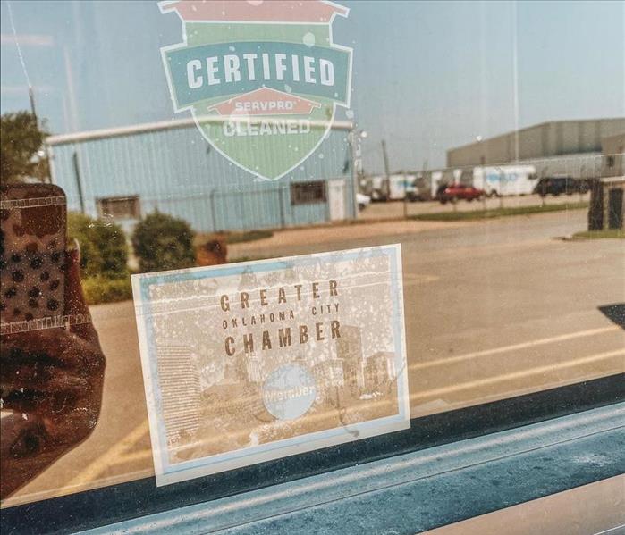 Window with a "Greater Oklahoma City Chamber of Commerce" membership sticker displayed in the middle. 