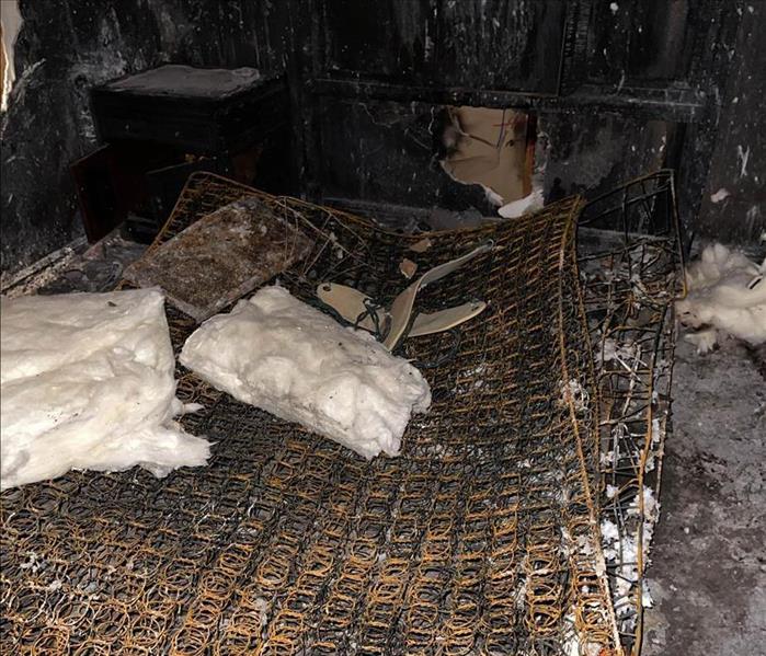 severe fire damage in home, the springs are all that is left of a mattress