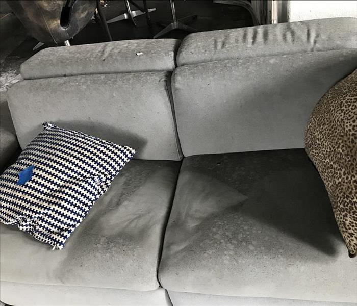 Couch with pillows moved to show affect of soot and ash. 