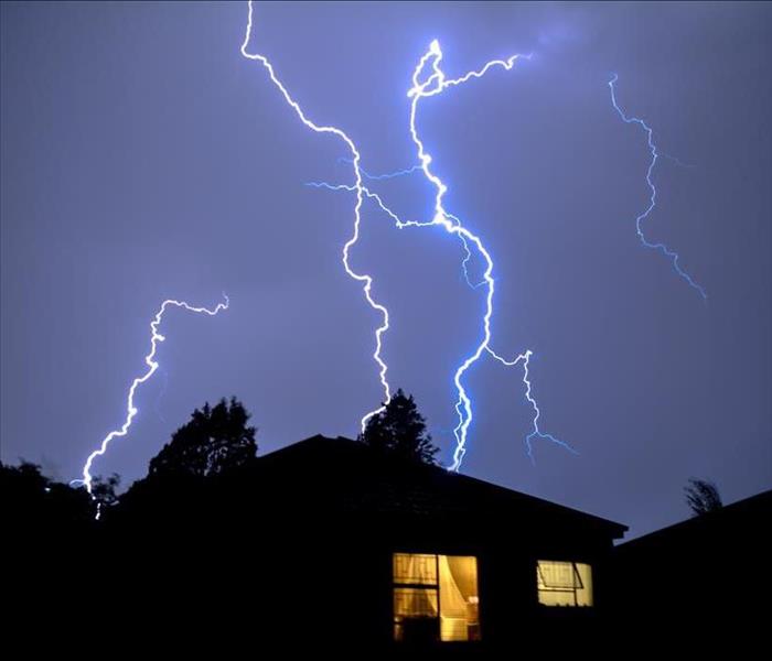 Lightning strike over a suburban home